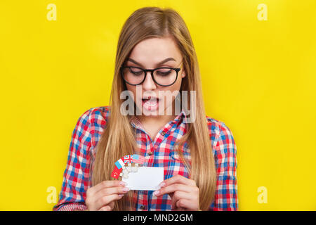 Young woman with card and flags of different speaking countries. Studio portrait of young beautiful female student Stock Photo