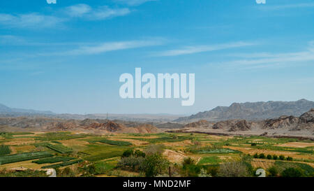 Rural landscape with fields seen from abandoned mud brick village of Kharanaq in Iran Stock Photo