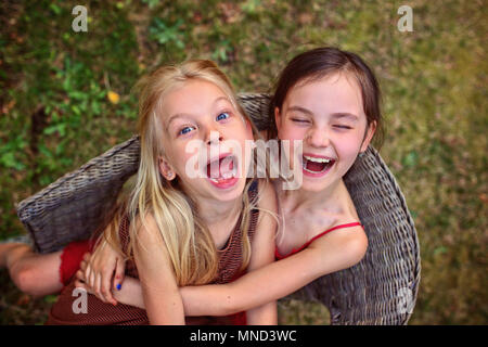 happy girls laugh and cuddle Stock Photo