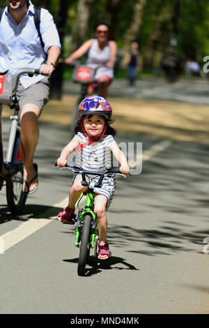 Young girl cycling, Hyde Park, London, United Kingdom Stock Photo