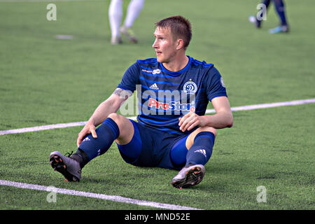 MINSK, BELARUS - MAY 14, 2018: Soccer player SAROKA ANTON seats on the grass during the Belarusian Premier League football match between FC Dynamo Minsk and FC Luch at the Olimpiyskiy stadium. Stock Photo