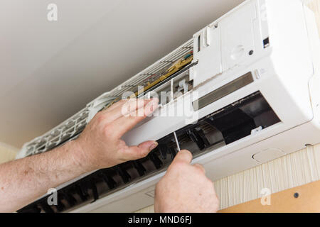Male hands with instruments make ac condition maintenance Stock Photo