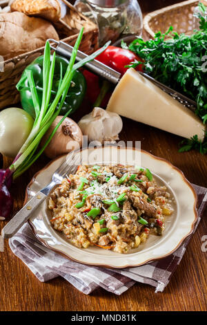 Risotto with champignon mushrooms, pork and parmesan. Italian cuisine