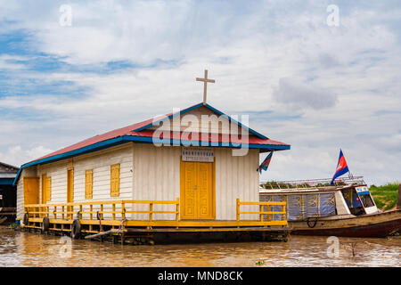 A floating wooden church house with a white Christian cross on the roof, yellow doors, windows and even a yellow handrail. Stock Photo