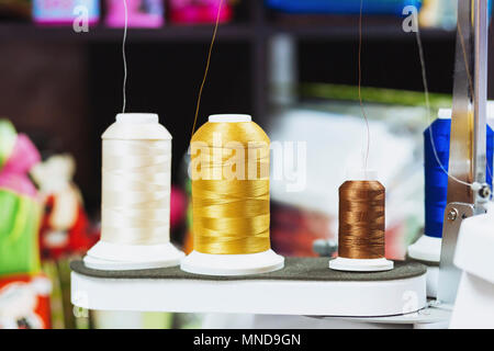 Close-up of various spools on sewing machine Stock Photo
