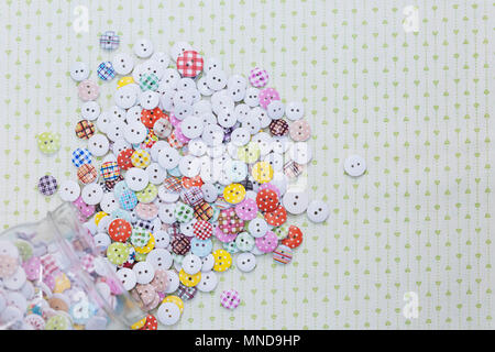 Directly above shot of multi colored various buttons on fabric Stock Photo