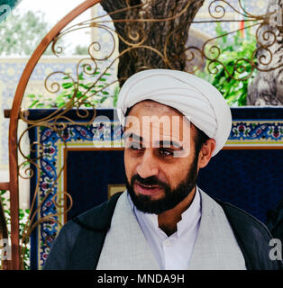 Isfahan, Iran - April 23, 2018: Portrait of a young Iranian Mullah wearing a keffiyeh in the courtyard of Jame Mosque Stock Photo
