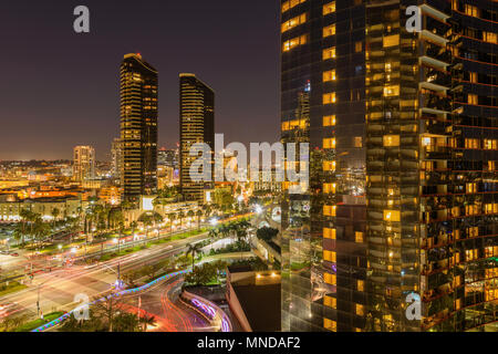 Night Street - An aerial night view of East Harbor Drive along Martin Luther King Jr. Promenade and a line of San Diego Trolley in Downtown, CA, USA. Stock Photo