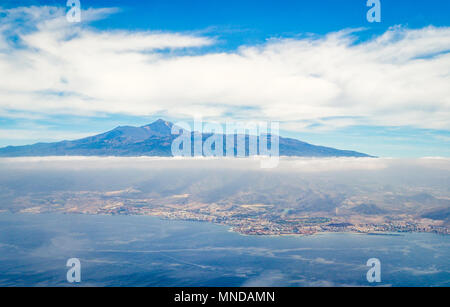 Aerial view of Mount Teide and the coast of Tenerife the largest of the Spanish Canary Islands from a plane landing at Tenerife South Stock Photo