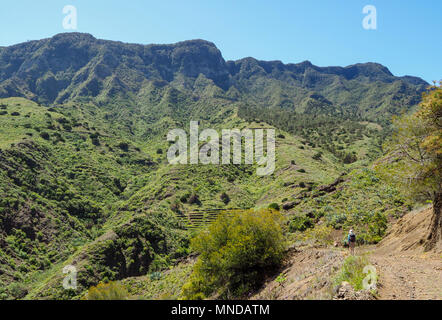 Woman walking in the mountainous landscape near Hermigua on the north coast of La Gomera in the Canary Islands Stock Photo
