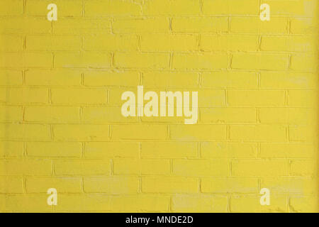 Yellow painted brick wall as a background or backdrop Stock Photo