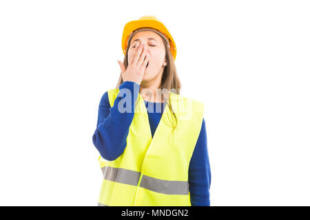Young female engineer or architect yawning and covering her mouth as tired sleepy concept isolated on white background Stock Photo
