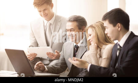 serious business team with tablet computers, documents having discussion in office Stock Photo