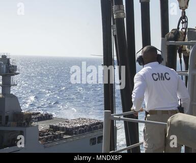 180515-N-AH771-0067 U.S. 5TH FLEET AREA OF OPERATIONS (May 15, 2018) Command Master Chief Ervin H. Byrd III, watches the dry cargo and ammunition ship USNS Amelia Earhart (T-AKE 6) come alongside the Wasp-class amphibious assault ship USS Iwo Jima (LHD 7) during a replenishment-at-sea, May 15, 2018, May 15, 2018. Iwo Jima, homeported in Mayport, Fla. is on deployment to the U.S. 5th Fleet area of operations in support of maritime security operations to reassure allies and partners, and preserve the freedom of navigation and the free flow of commerce in the region. (U.S. Navy photo by Mass Comm Stock Photo