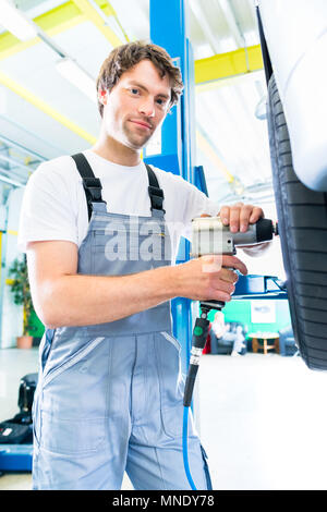 Mechanic tire change in car workshop Stock Photo