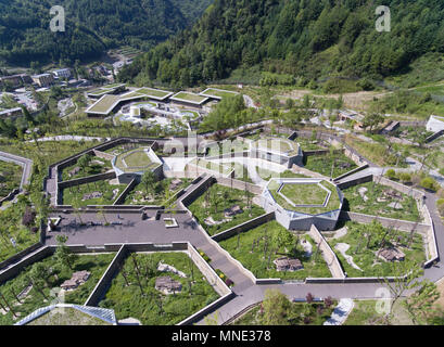 Gengda Township, China. 16th May 2018. Aerial photo taken on May 16, 2018 shows the Shenshuping giant panda protection base of Wolong National Nature Reserve in Gengda Township, southwest China's Sichuan Province. The Wolong reserve, some 30 kilometers away from the epicenter of the devastating 2008 earthquake, was severely damaged in the disaster. As a result, some pandas inhabiting the reserve had to be relocated in zoos after the quake. Credit: Xinhua/Alamy Live News Stock Photo