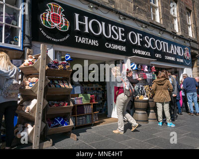 Royal Mile, Edinburgh, 16th May 2018. Tourists enjoying the sunshine on Royal Mile, Edinburgh, Scotland, United Kingdom. Tourists browse a souvenir shop called House of Scotland, with the usual tartan goods for sale Stock Photo