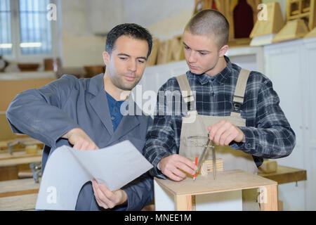 two designers working together in workshop with precision tools Stock Photo