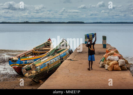 Bunce Island, Sierra Leone - June 02, 2013: West Africa, unknown fisherman unloads the material from the dock, Bunce Island was a British slave tradin Stock Photo