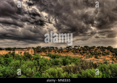 Spectacular view on the hill and greenery with dark, dramatic, stormy clouds in Segovia, Spain. Stock Photo