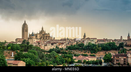 Panoramic view with the dramatic stormy clouds on the Santa Maria Cathedral in Segovia city in Spain. Stock Photo