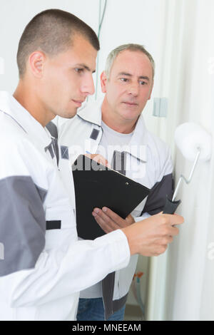observing the brushing technique of the apprentice Stock Photo