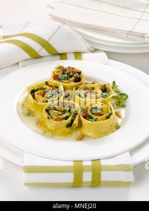 Gratinated pasta rolls with fresh herbs and pine nuts Stock Photo