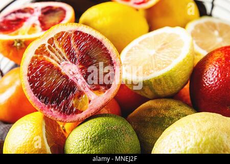 Various citrus fruit in a wire basket Stock Photo
