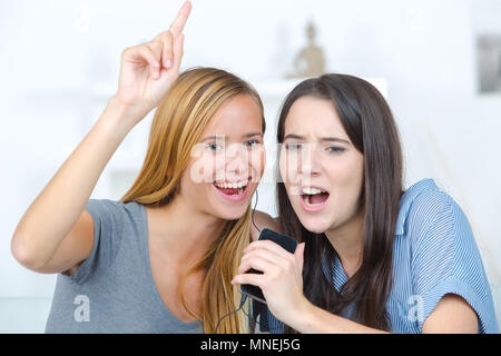 excited friends listening music and singing Stock Photo