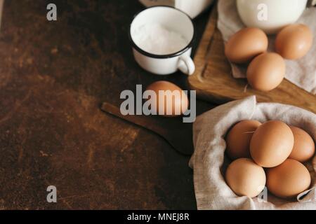 Fresh chicken eggs and a cup of icing sugar Stock Photo