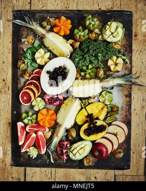 Various fruits on a vintage tray Healthy greens Stock Photo