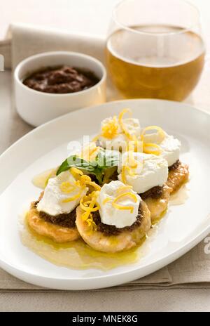 Mini chicken escalopes with olive cream, ricotta and lemon zest Stock Photo
