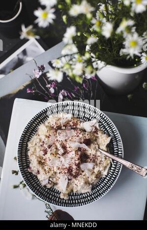 Overnight oats or bircher muesli with coconut and cranberries (Seen from above)