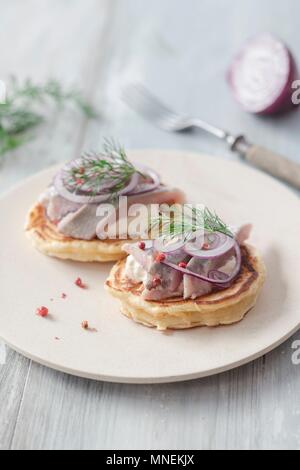 Pancakes with herring, onions and dill Stock Photo