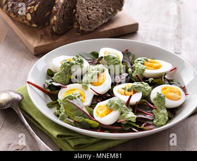 Boiled eggs with herb mayonnaise on lettuce Stock Photo