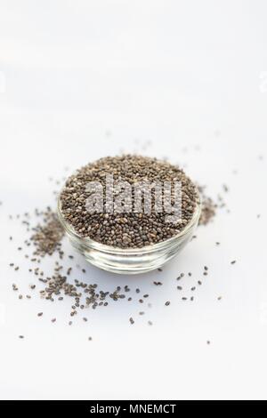 Chia seeds in a glass bowl in front of a white background Stock Photo