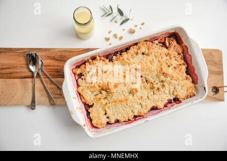 Apple crumble with custard Stock Photo