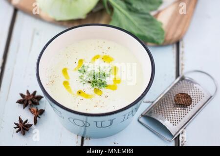 Kohlrabi soup with cress, olive oil, nutmeg and star anise Stock Photo