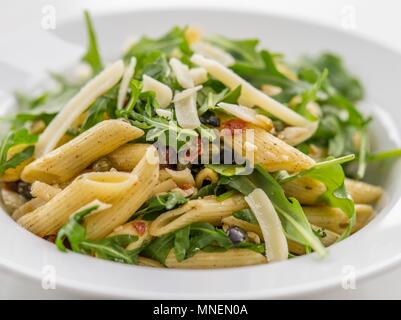 Pasta salad with rocket, dried tomatoes and Parmesan cheese (close-up) Stock Photo