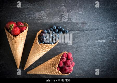 Various berries in ice cream cones Stock Photo