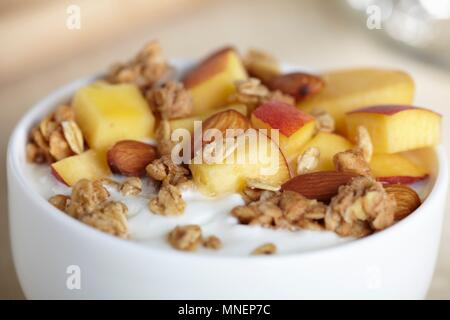 Greek Yogurt with Granola, Almonds and Peaches Stock Photo