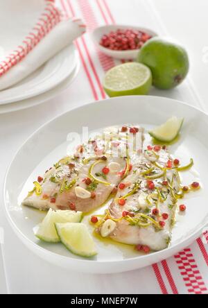 Mackerel fillets with pink pepper, limes and garlic Stock Photo