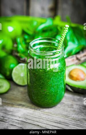 A green smoothie on a rustic wooden surface Stock Photo