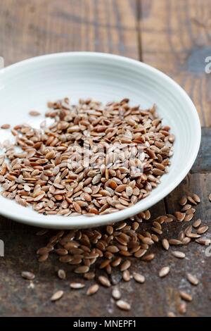 A bowl of brown flax seeds Stock Photo
