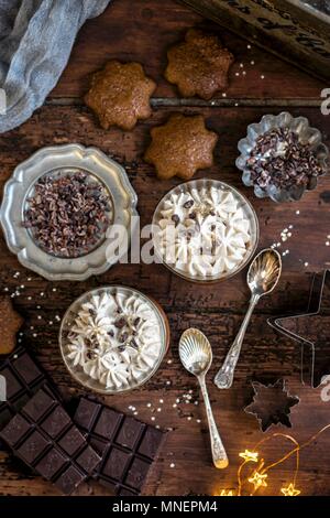 Vegan chocolate and coconut mousse made with aquafaba (chickpea brine) served with star-shaped gingerbread cookies Stock Photo