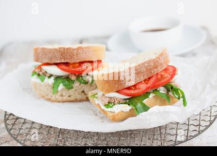 Ciabatta sandwiches with tuna fish, quark, rocket, tomatoes and egg Stock Photo