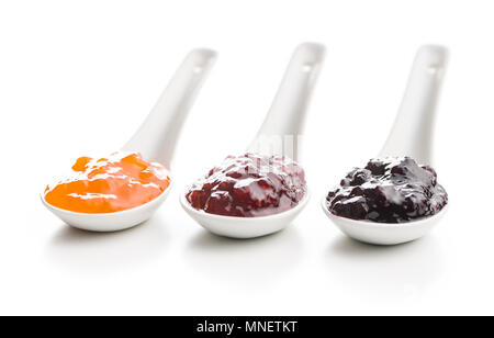 Tasty fruity jam in ceramic spoon isolated on white background. Stock Photo