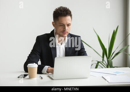 Serious businessman working at laptop Stock Photo
