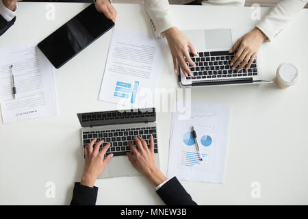 Top view of colleagues working with laptops during meeting Stock Photo
