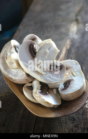 Pieces of chopped mushrooms on a wooden background. Close up. Copy space Stock Photo